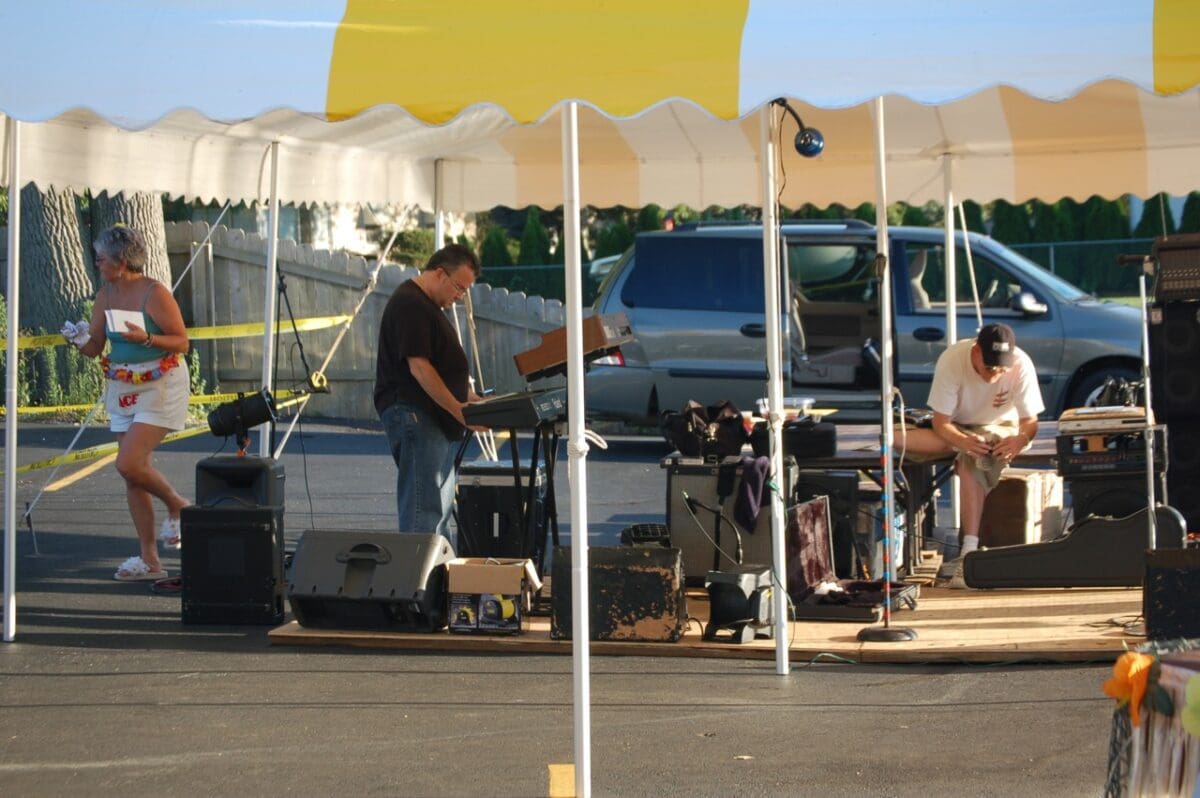 Musicians performing at an outdoor club gathering