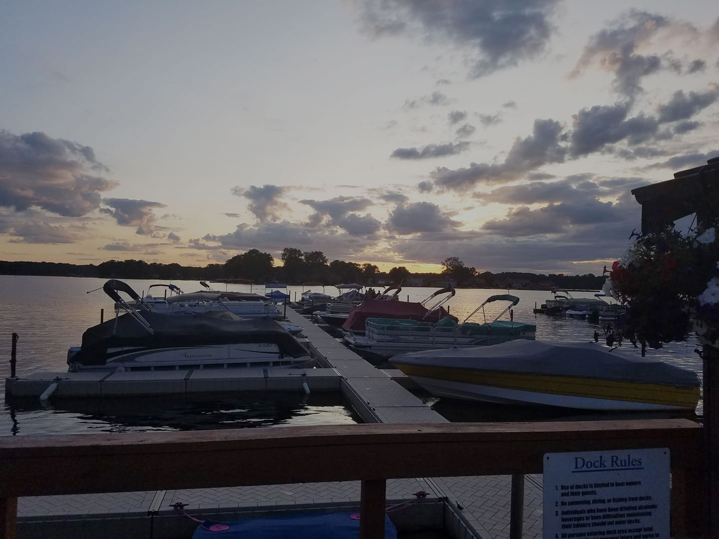 Boats at La Porte Yacht Club docks on Pine Lake at sunset
